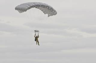 Paratroopers glide down to the runway at Nellis Air Force Base, kicking off the start of Aviation Nation on Veteran's Day, Friday Nov. 11, 2011.
